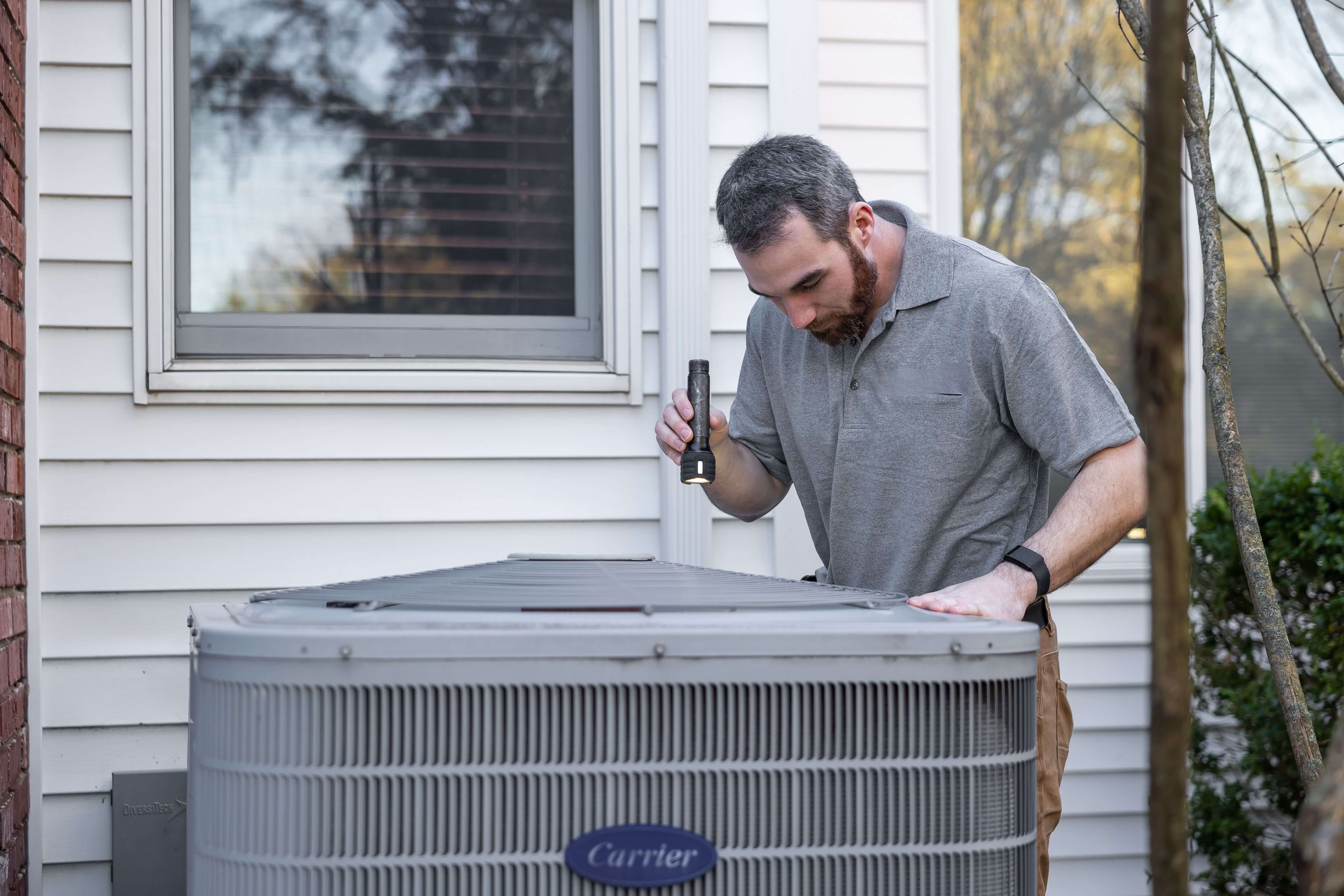 HVAC technician servicing heat pump